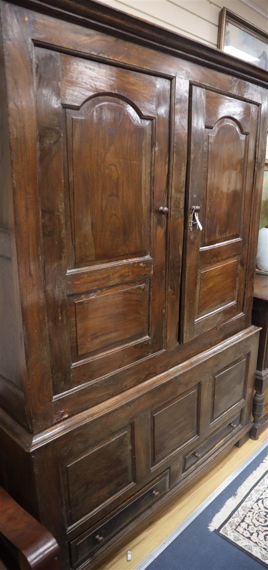 A mid 18th century walnut press cupboard, with two panelled doors and two base drawers, on stile feet W.135cm